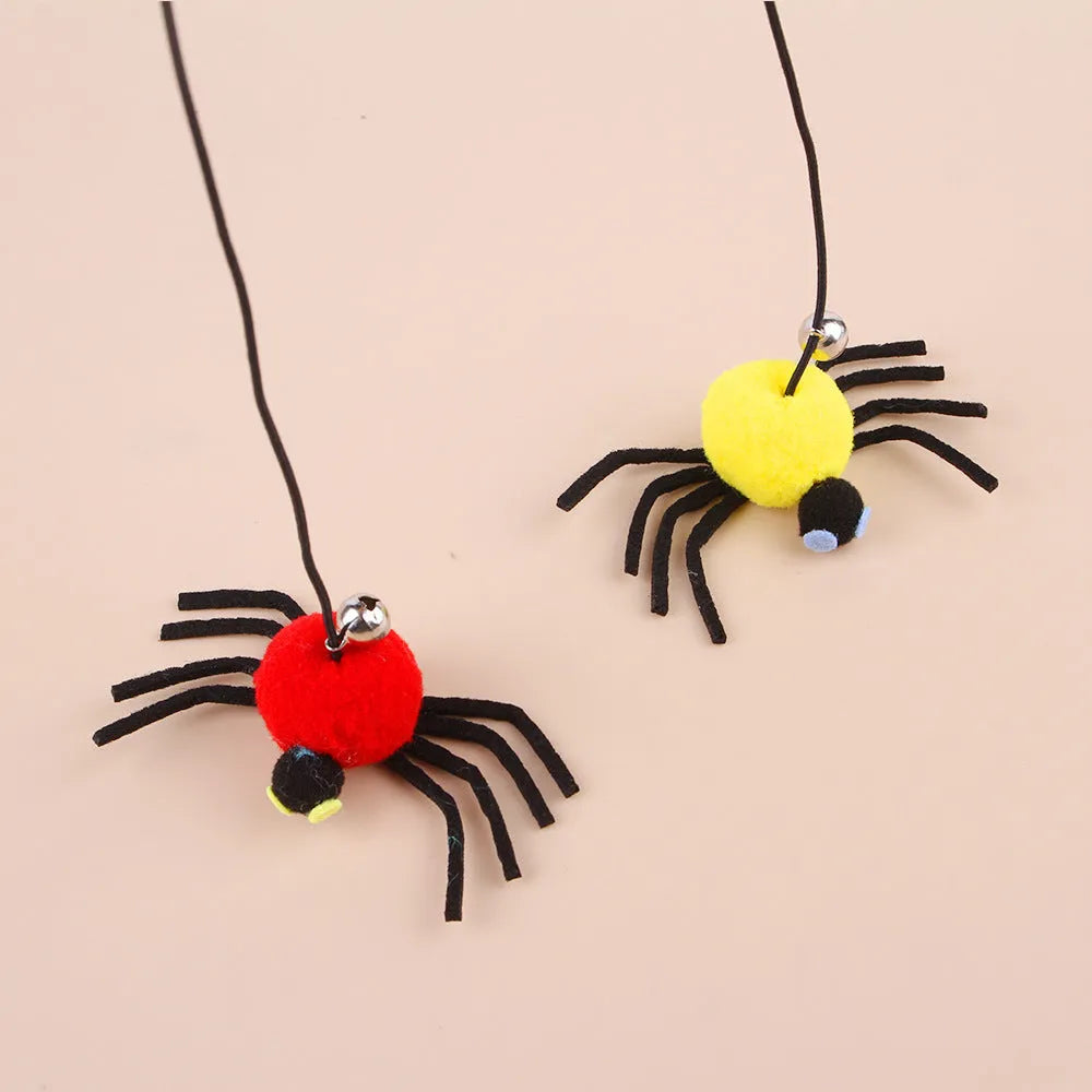 Red cat toy hanging from door with elastic rope, feather stick, bell, and spider decoration