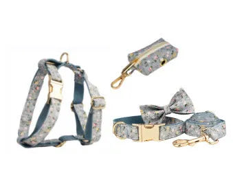 Blue floral pattern dog collar set with matching leash, vest, and accessories on white background