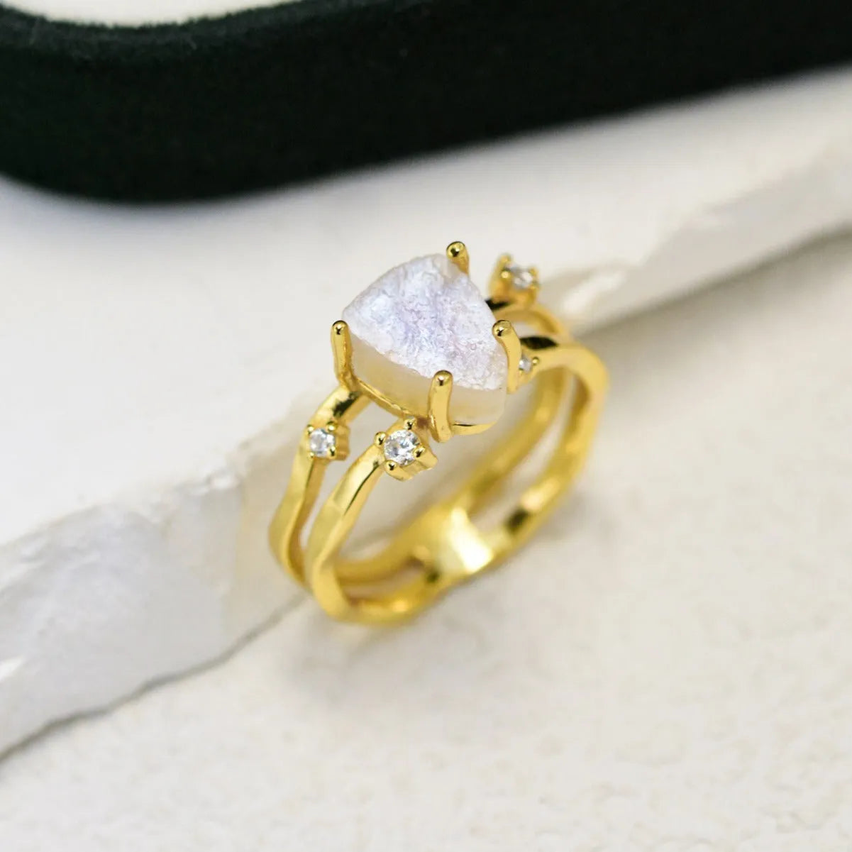 S925 silver irregular triangle moonstone ring in rose gold, white gold, or yellow gold colour on a hand.