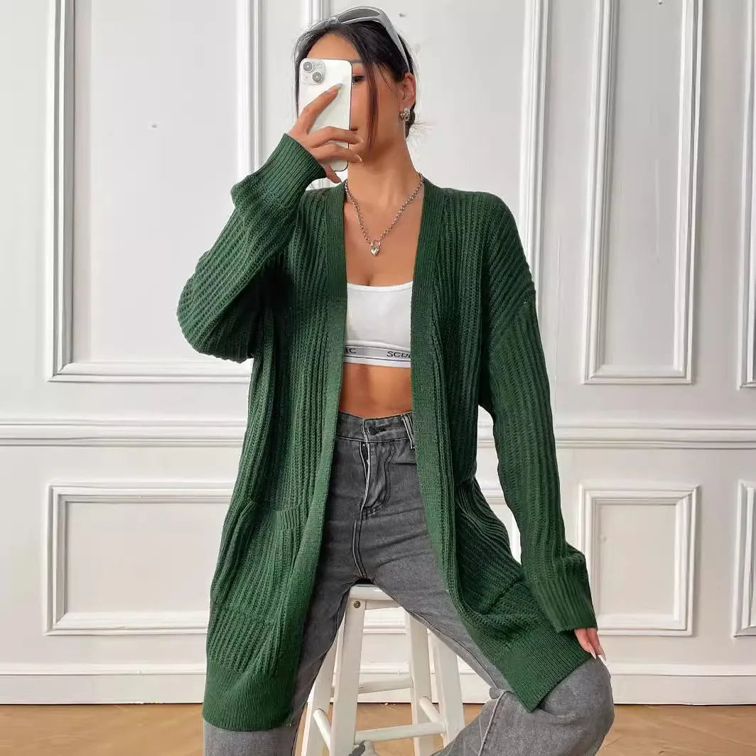 Women's dark green loose-fit cardigan sweater with two front pockets and long sleeves.