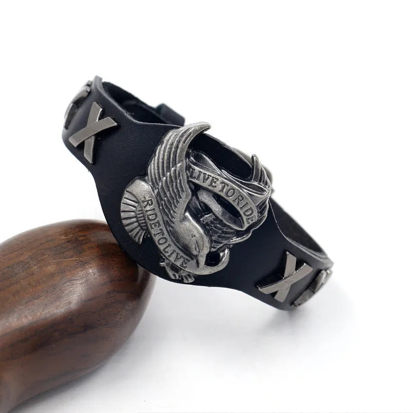 Black geometric leather bracelet with eagle watch-button clasp showing tapered width from 3.8cm to 1.7cm