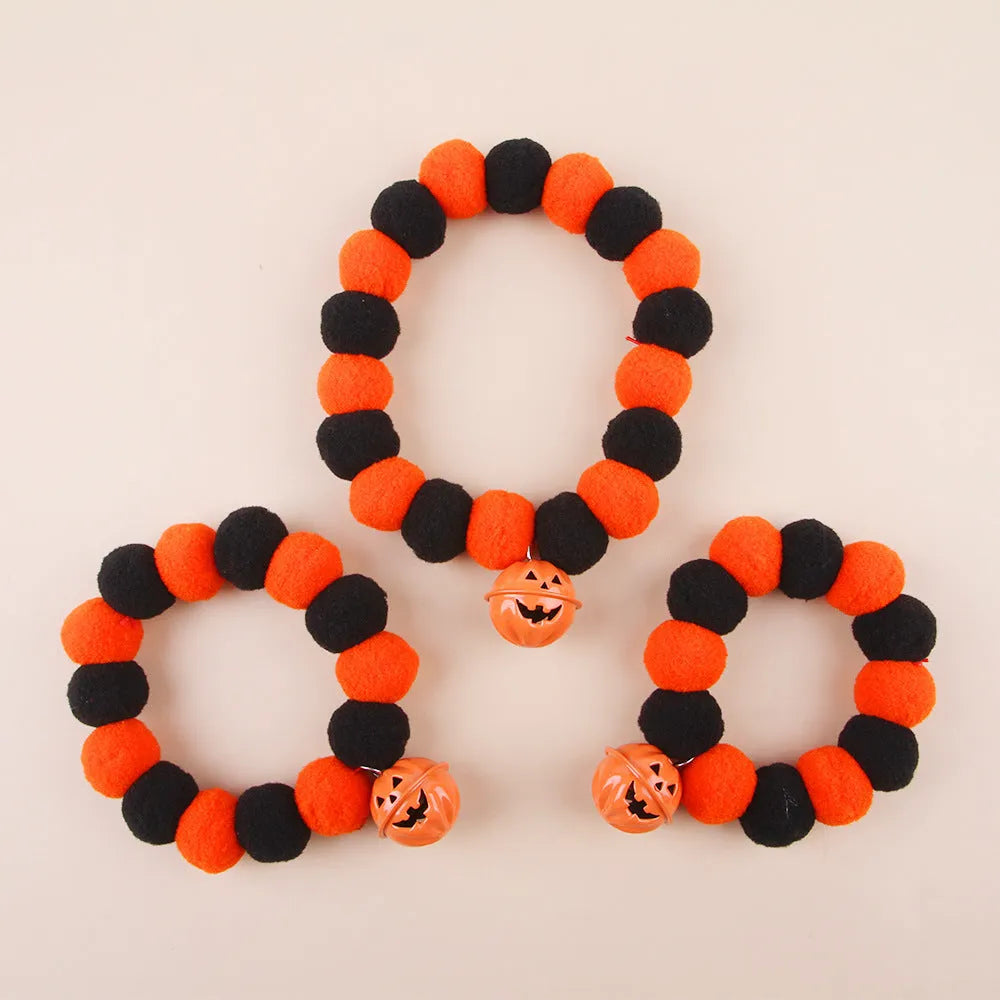 Orange Halloween pumpkin print cat collar with black cat silhouette and green stem.