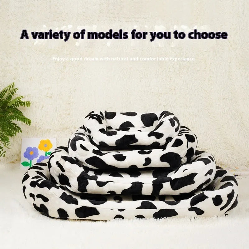 Four Seasons Universal Kennel dog bed in cow colour cloth, size M 40x50cm, with a dog resting on it.