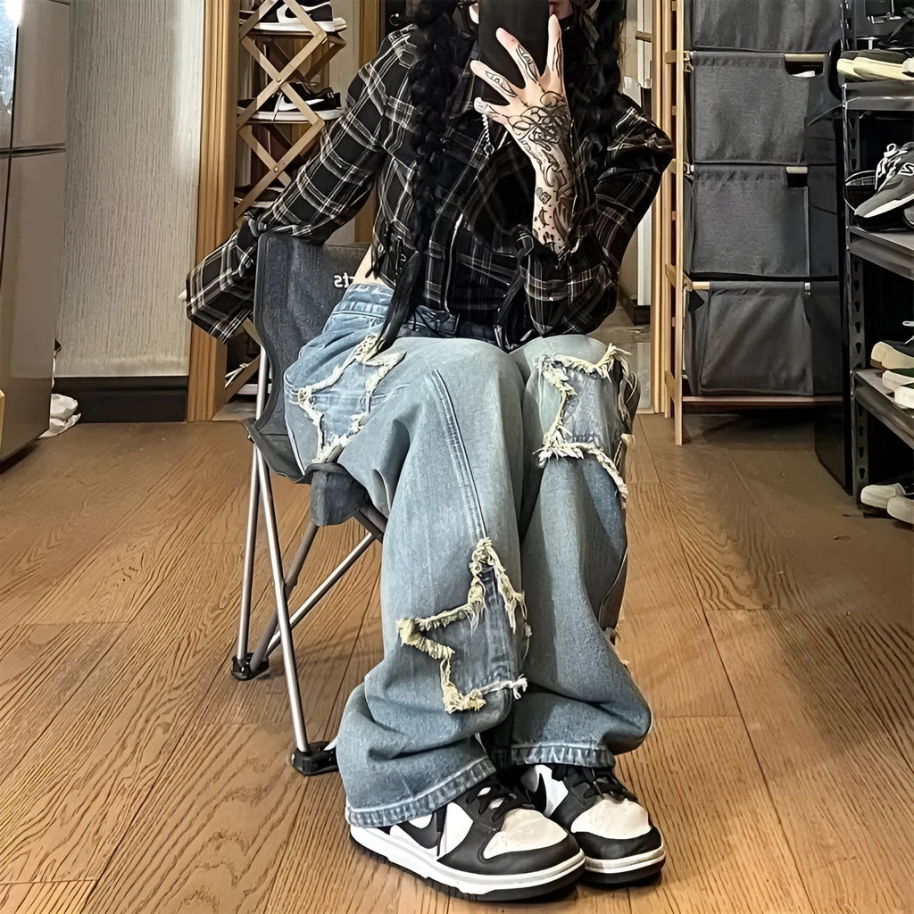 Blue high waist women's wide-leg denim trousers laid flat, showing straight leg cut and button fastening.