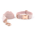Pink velvet pet collar with rose gold hardware and matching leash on a white background