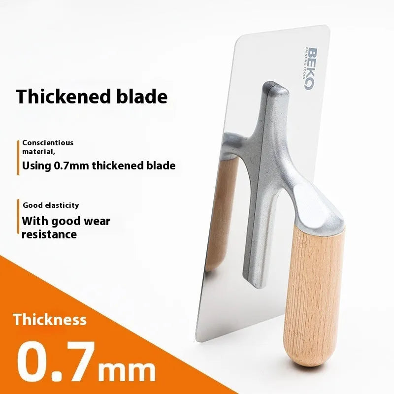 Stainless steel putty scraper with wooden handle for floor and wall decoration work.