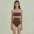 Brown women's triangle one-piece swimsuit with a pattern, shown on a hanger