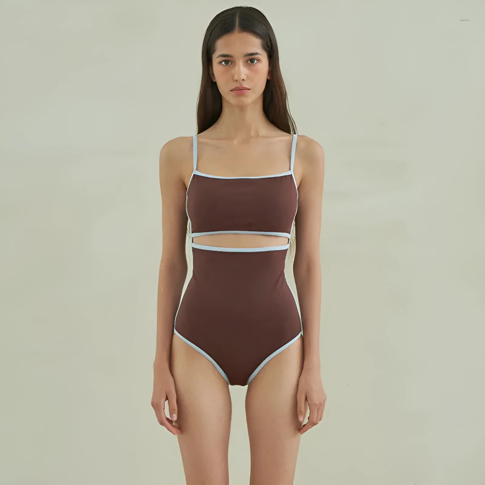 Brown women's triangle one-piece swimsuit with a pattern, shown on a hanger