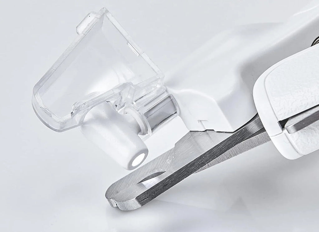 White pet nail clippers with LED light, transparent anti-splash guard open, and separate nail file.