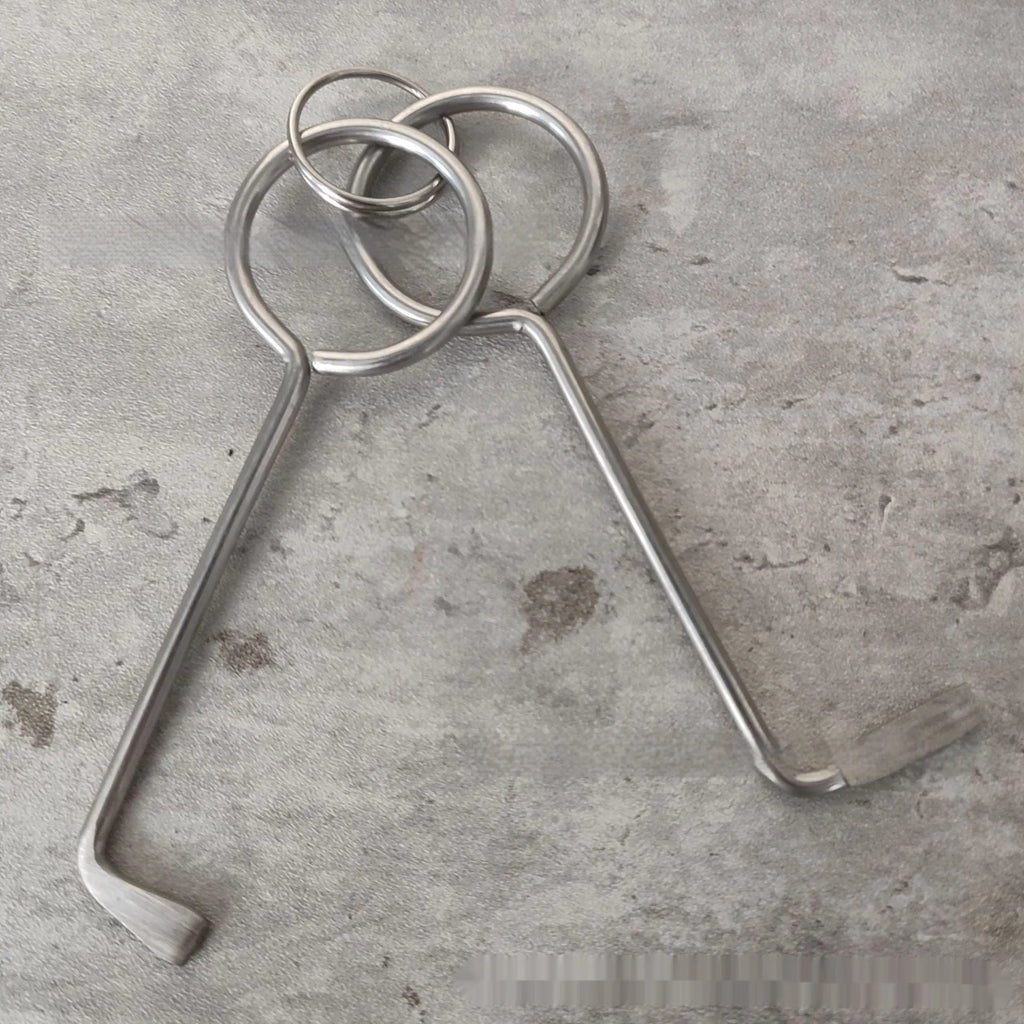 Two alloy wrench tools from a portable household tool set on a plain background.