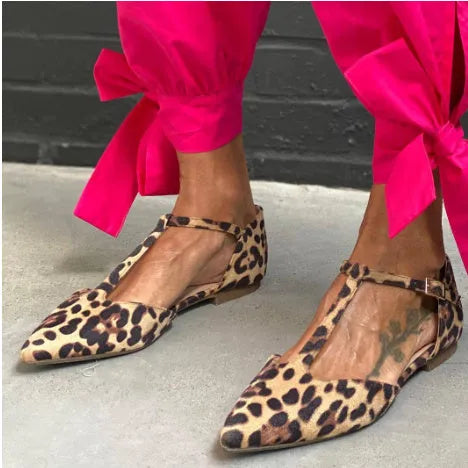 Leopard print women's pumps with pointed toe, chunky low heel, and cross shoulder straps