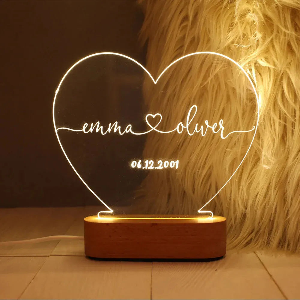 Personalised acrylic night light with engraved names and dates, measuring 20cm by 11.5cm