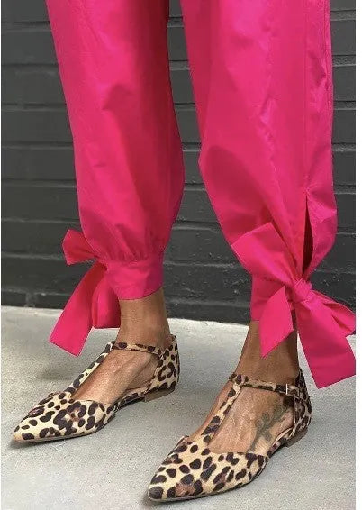 Leopard print women's pumps with pointed toe, chunky low heel, and cross shoulder straps
