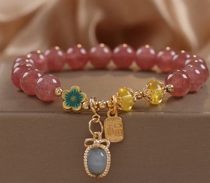 Red strawberry quartz design beaded bracelet for women with alloy metal and rhinestones.