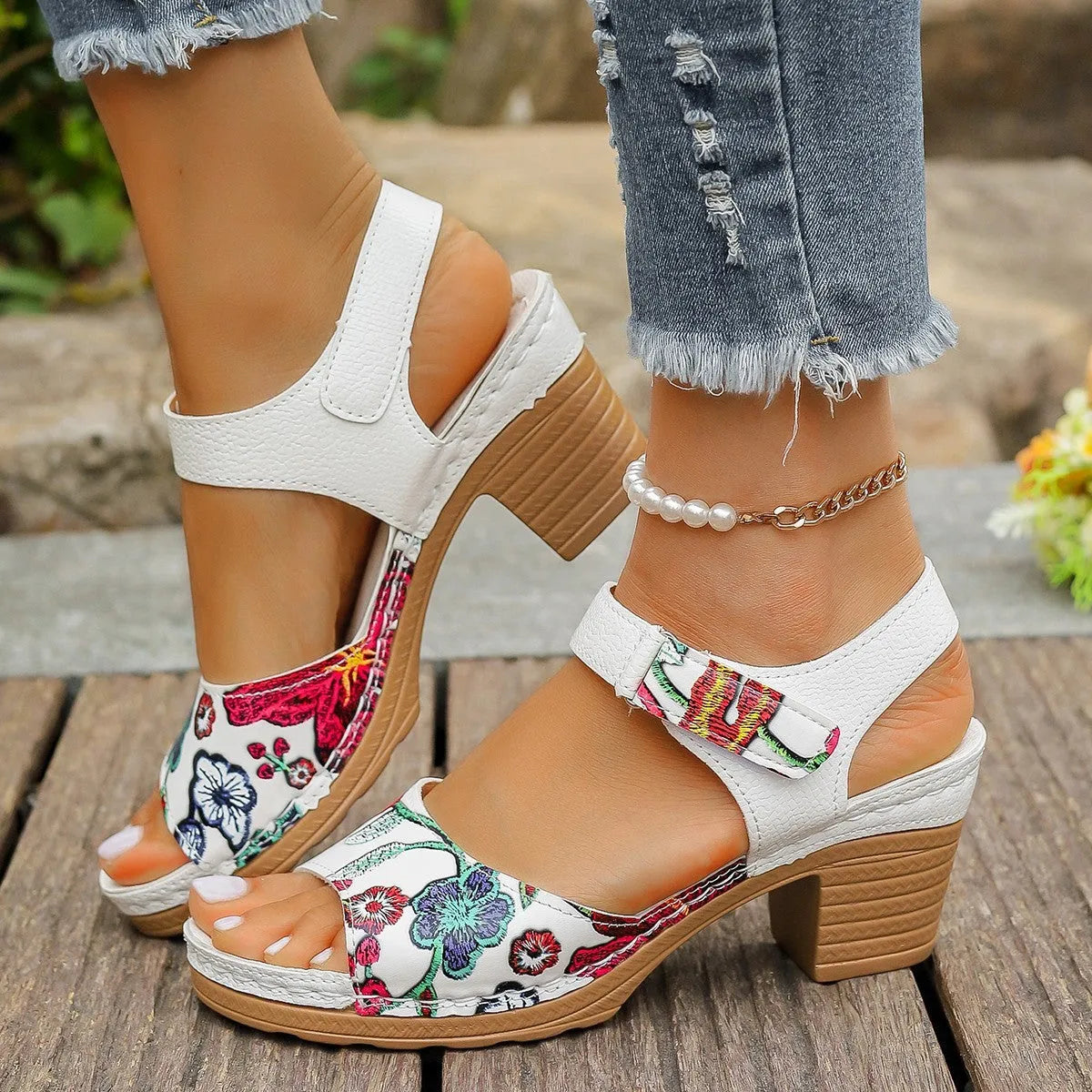 White women's high heel sandals with an adjustable Velcro strap buckle on the ankle.