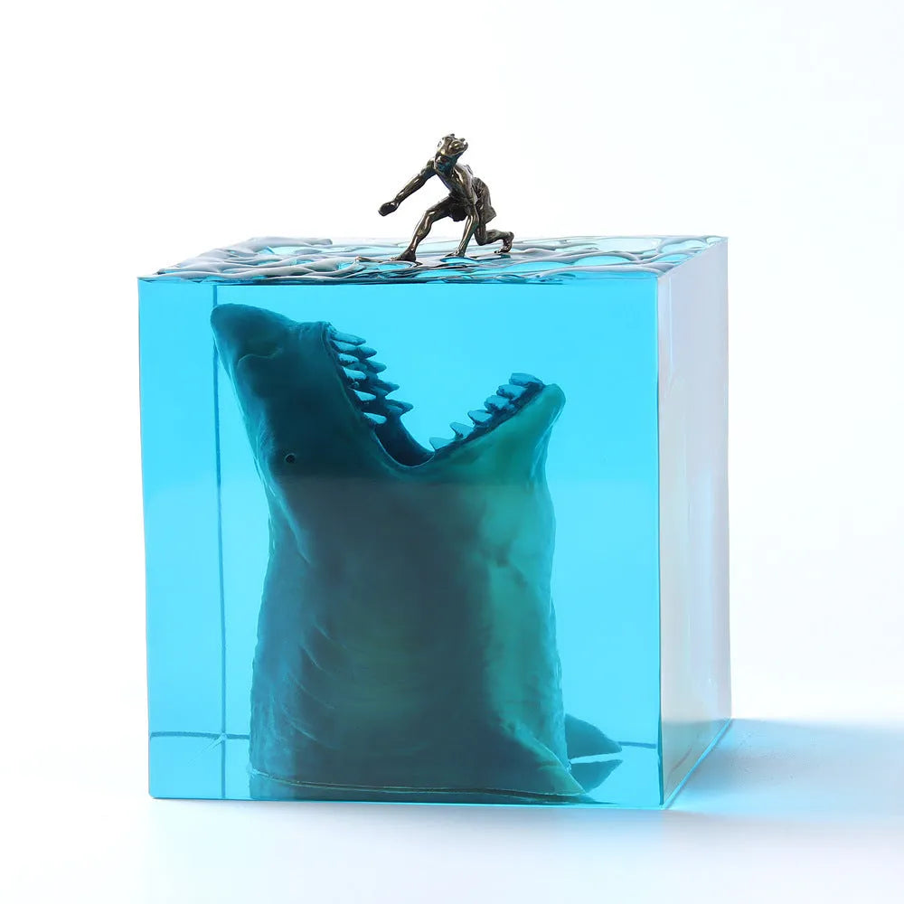 Clear epoxy resin ornament with shark surfer scene inside, next to 5cm and 8cm size options.