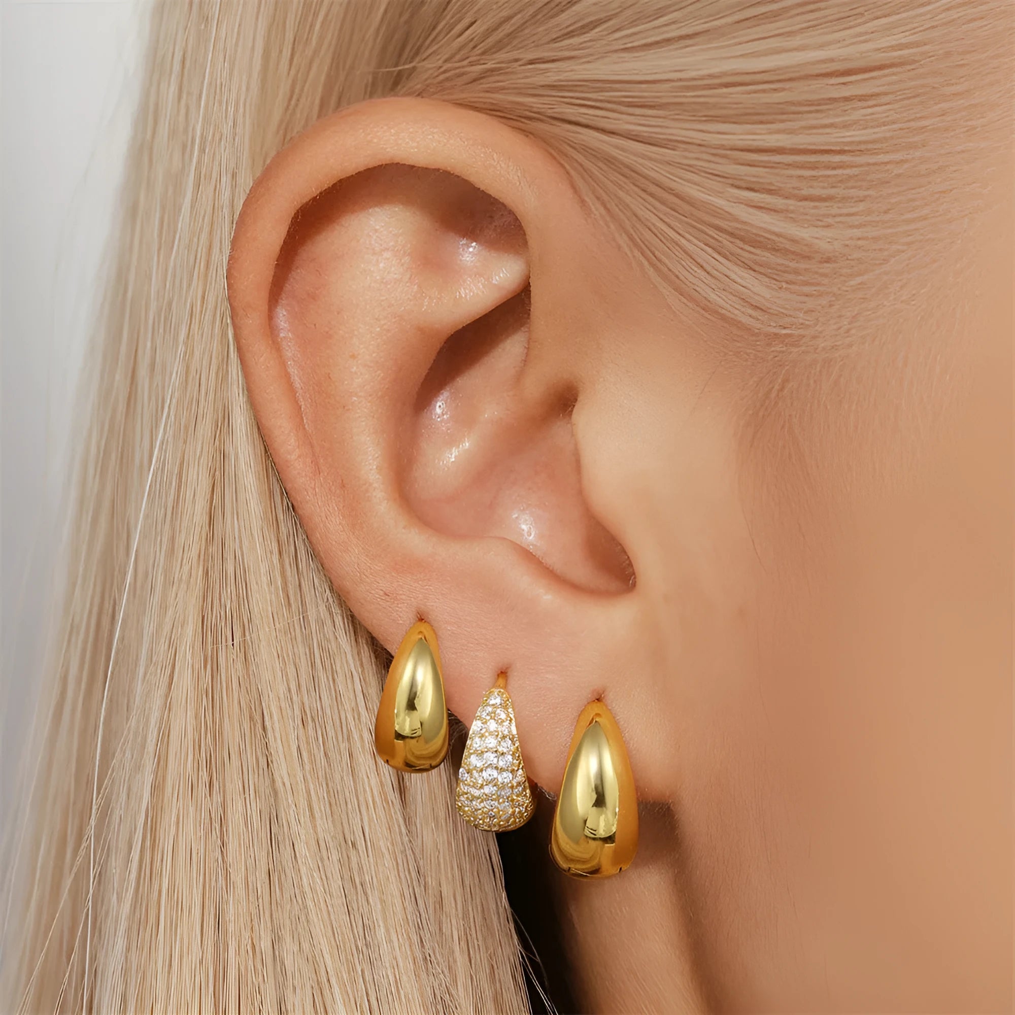 Golden geometric clip-on earrings with round design elements and electroplated finish