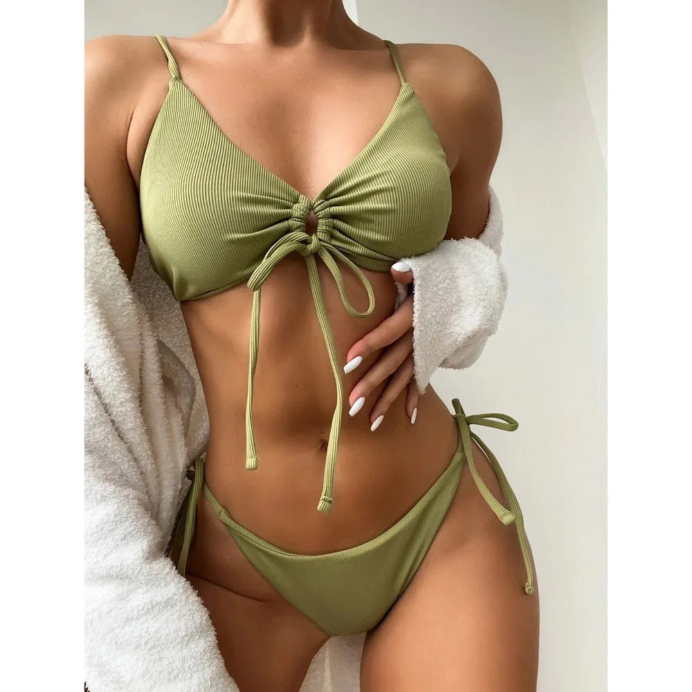 Women's solid colour drawstring bikini swimsuit in army green on a neutral background.
