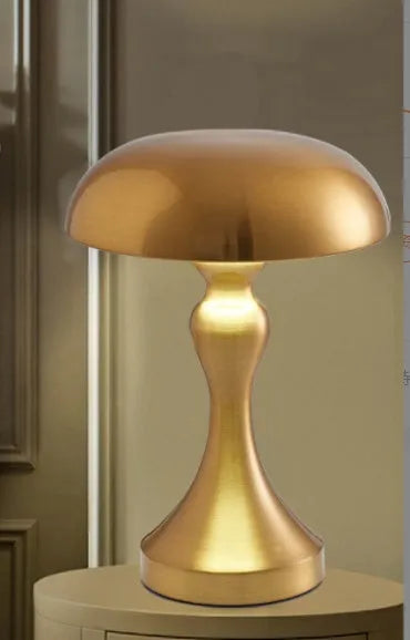 Bronze finish USB rechargeable desk lamp with touch control for three light colours on a wooden desk.