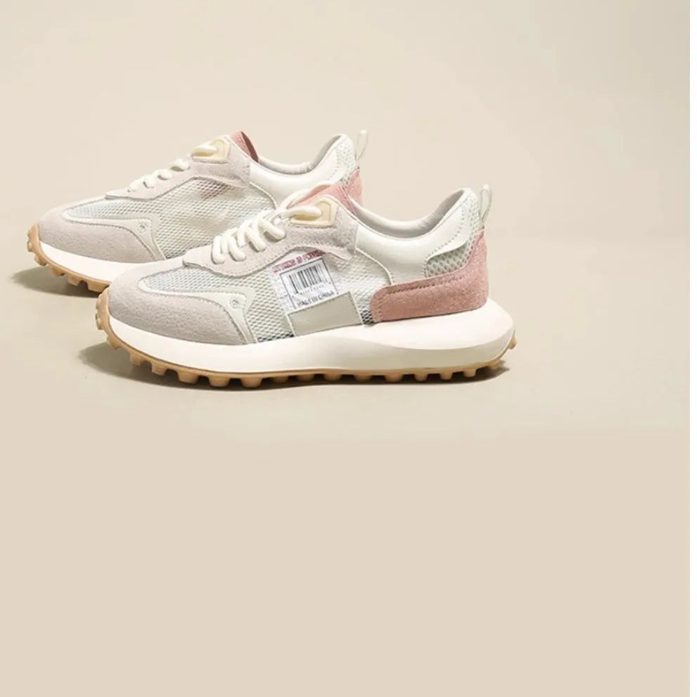 Women's grey and pink low-top retro sneakers with a round toe and flat rubber sole.