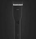 Black and white cordless Boost hair clipper with adjustable slider comb and nano ceramic cutter head.