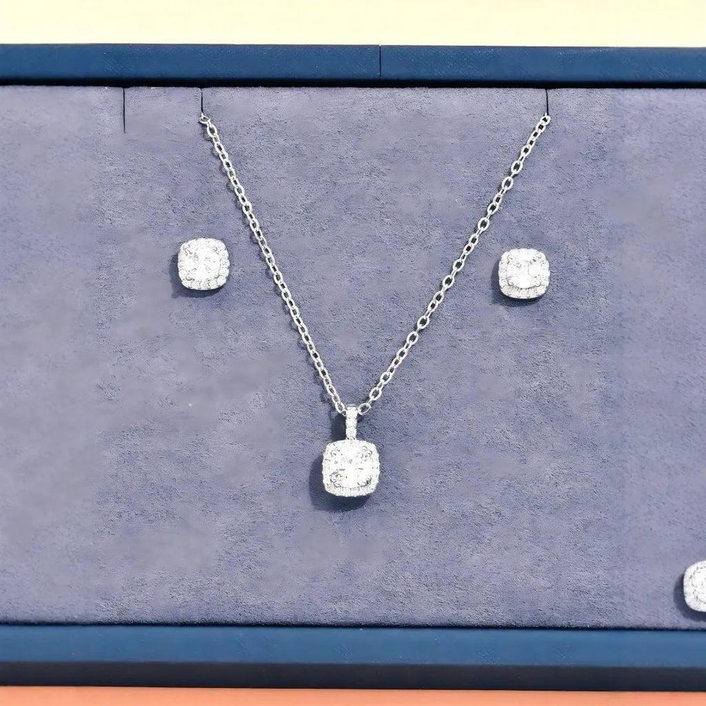 Women's minimalist square cubic zirconia necklace and earring set in gold finish on a light background