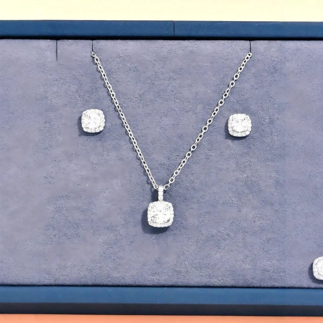 Women's minimalist square cubic zirconia necklace and earring set in gold finish on a light background
