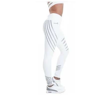 Woman wearing black glow-in-the-dark printed milk silk workout leggings for fitness.
