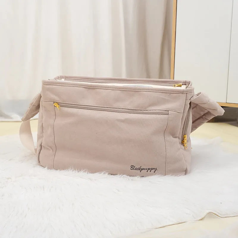 Large capacity soft surface messenger pet carrier bag in beige with small dog inside