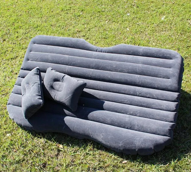Ultra-thickened flocking cloth inflatable bed set up on a car rear seat with two pillows.
