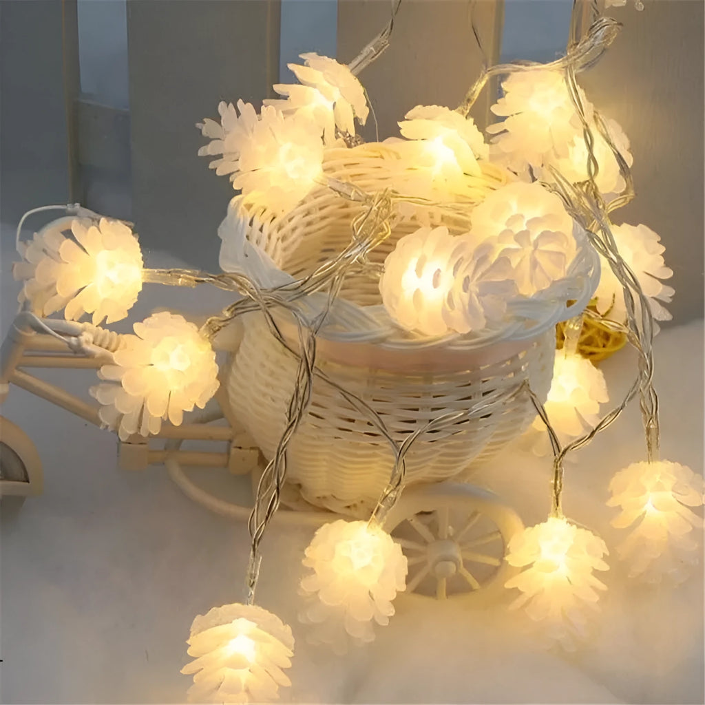 Warm white LED pine cone fairy light string on a green pine branch for decorative lighting