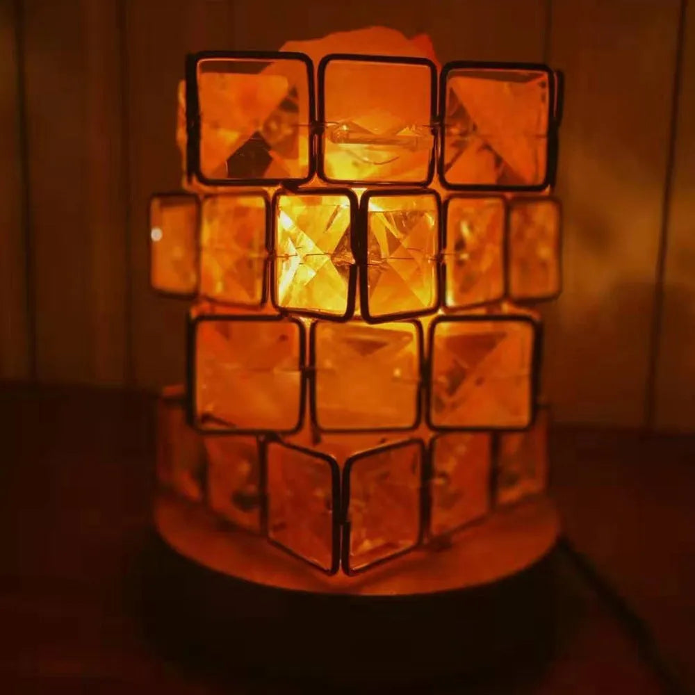 Himalayan crystal salt lamp with dimmer switch on wooden base emitting warm amber glow
