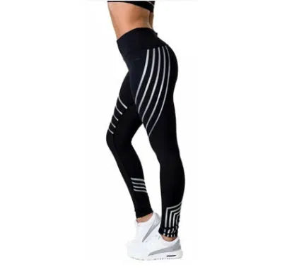 Woman wearing black glow-in-the-dark printed milk silk workout leggings for fitness.