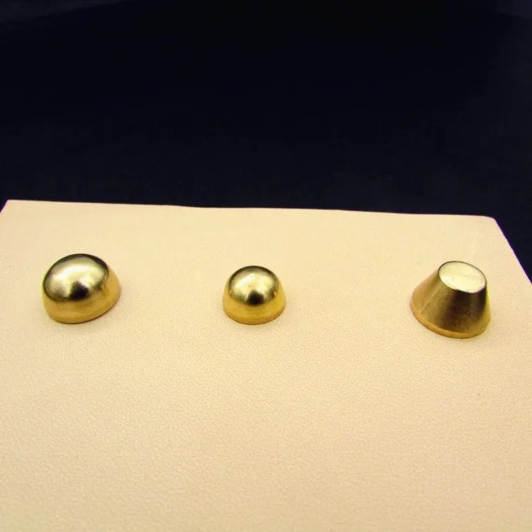 Solid brass decorative buckle for clothing in round and geometric foot nail designs.