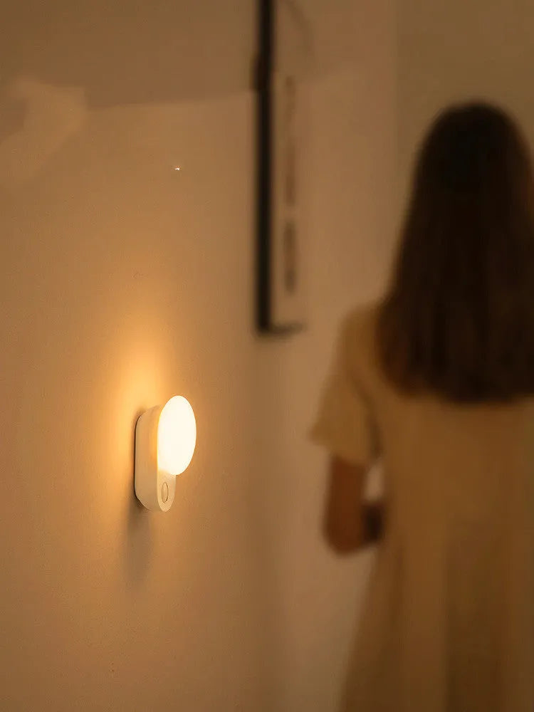 White Baseus rechargeable motion sensor bedside night light with USB port.