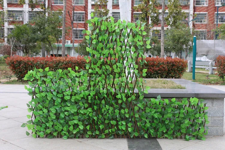 Telescopic garden simulation fence in wood-effect plastic on flowerbed border