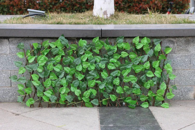 Telescopic garden simulation fence in wood-effect plastic on flowerbed border