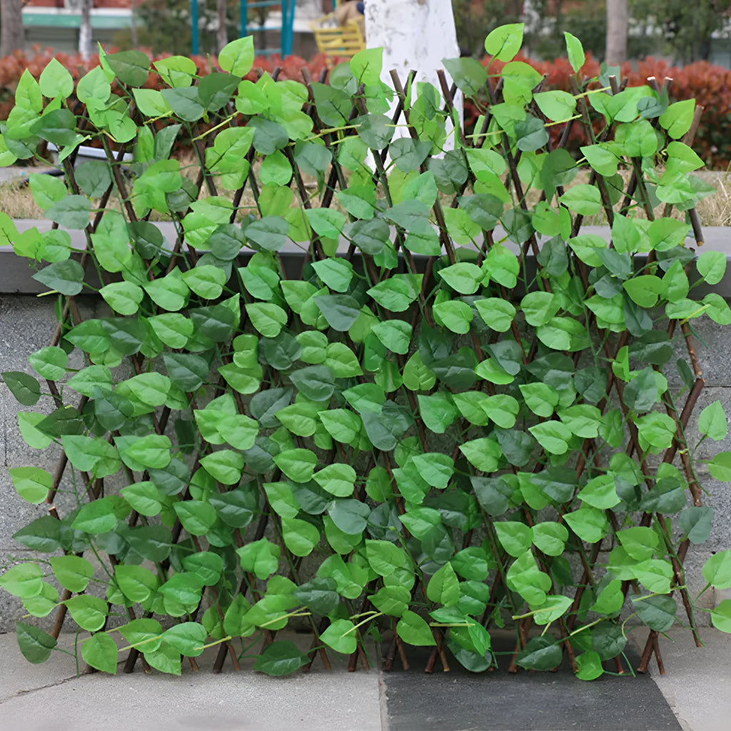 Telescopic garden simulation fence in wood-effect plastic on flowerbed border
