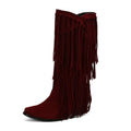 Women's suede high boots with tassel detail, chunky heel, and waterproof platform sole in beige colour.