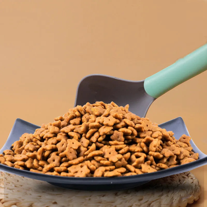 Plastic pet food spoon 21cm long with blue handle on white background