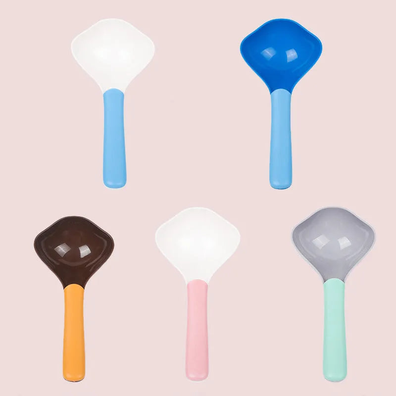 Plastic pet food spoon 21cm long with blue handle on white background