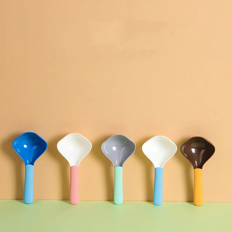 Plastic pet food spoon 21cm long with blue handle on white background