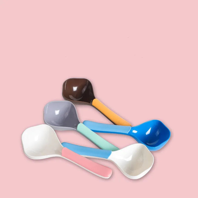 Plastic pet food spoon 21cm long with blue handle on white background