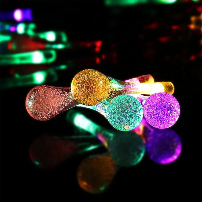 30 LED solar-powered water drop shaped string lights on a 6.5m cable for outdoor garden use.
