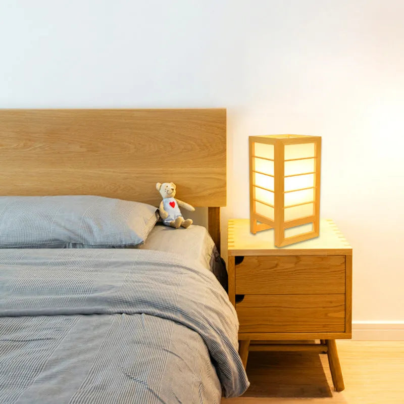 Simple Korean-style bedside table lamp with a solid bamboo wood base on a nightstand.