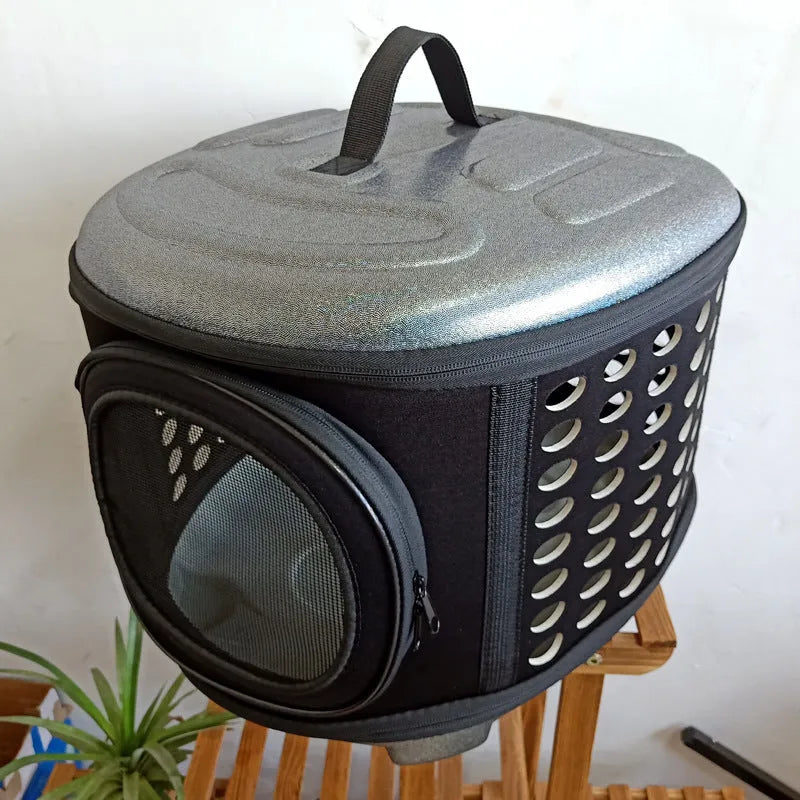 Black folding pet carrier bag with anti-tear mesh door and ventilation holes, for cats and small dogs.