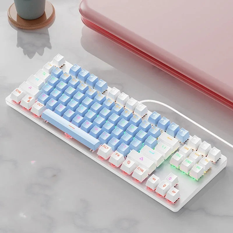 Red and black 87-key compact mechanical keyboard with green axis switches on a desk, shown with blue mixed light backlight