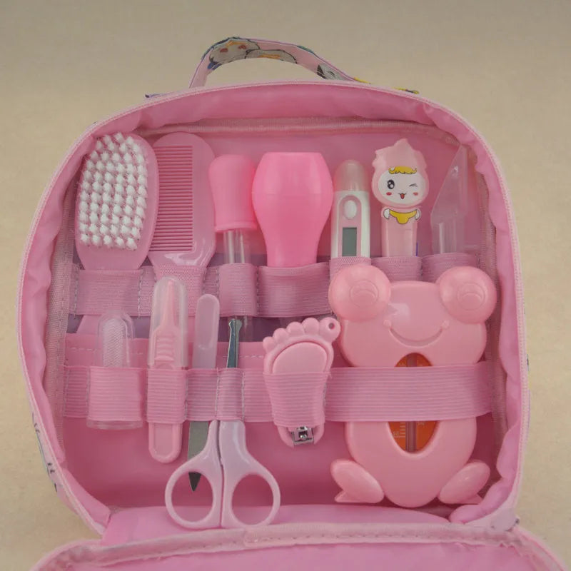 13-piece newborn baby care kit with pink grooming bag containing thermometer, scissors, brush, comb, nail clipper, and medicine tools