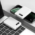 Black and white portable power bank showing USB ports and compact rectangular design