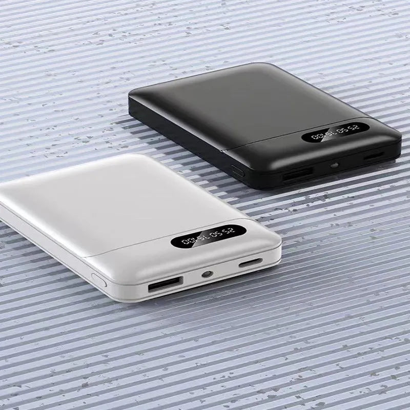 Black and white portable power bank showing USB ports and compact rectangular design